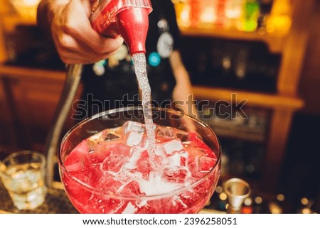 bartender prepares a great cocktail close-up on the background of the bar