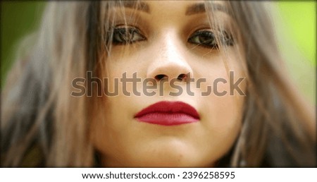 Millennial girl face portrait looking to camera. Young woman in 20s posing