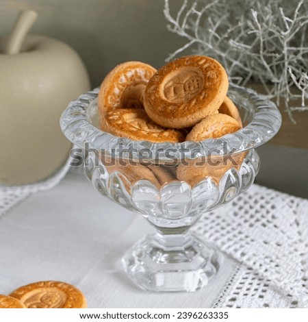 cookies in a glass vase   on a light, wooden background