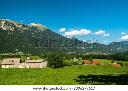 Beautiful panorama idyllic view of Veliki Stol (Hochstuhl) massif at border between Slovenia and Austria with pasture in foreground on a sunny summer day from Bled with blue sky cloud. Royalty-Free Stock Photo #2396279617