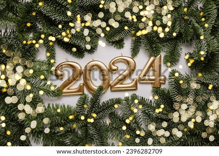 Holiday background Happy New Year 2024. Numbers of year 2024 made by gold candles on background with fir tree. celebrating New Year holiday, close-up. Space for text