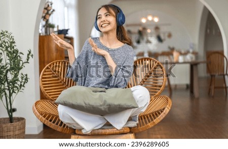 Portrait of smiling beauty asian woman happy and relax listening to music with headphones and singing, happy calm, resting ,good healthy, podcast, sound audio, listen online song at home