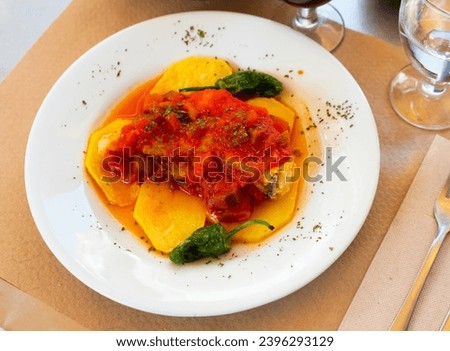 Popular spanish dish cod with sanfaina, sauteed vegetables and tomato sauce