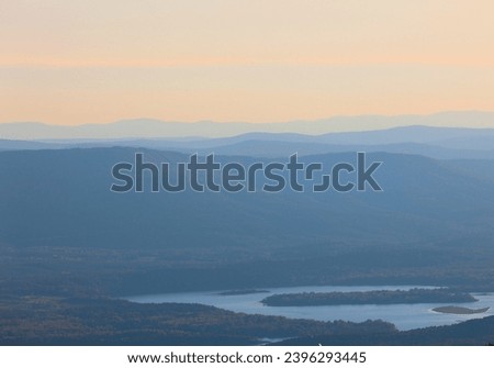 View of Blue Mountain Lake from The Lodge at Mount Magazine State Park at sunset.
