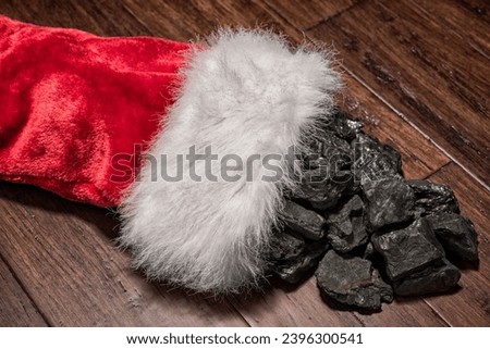 Someone is on the naughty list as a Christmas Stocking full of coal is spilling on floor