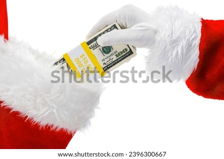 Santa Clause's hand placing a bundle of US 100 bills into a Christmas Stocking isolated