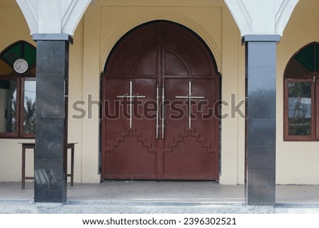 The front door of the church is designed with cross signs and symbols