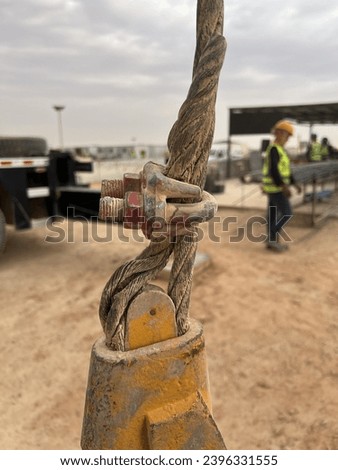 A wrong application of u clamp with wire rope termination attached with  mobile crane hook block Royalty-Free Stock Photo #2396331555