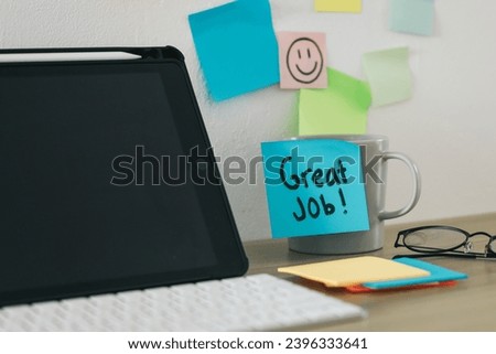 Sticky notes with Great Job text on a mug at office desk Royalty-Free Stock Photo #2396333641