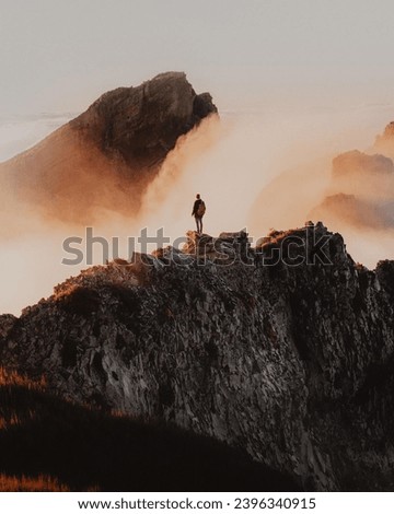 A person standing on top of a mountain  Royalty-Free Stock Photo #2396340915