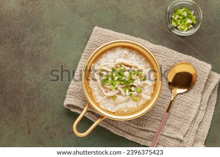 Dakjuk. Korean rice chicken porridge with spring onions. Top view Royalty-Free Stock Photo #2396375423