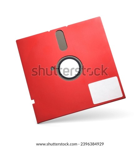 Red 5.25 inch retro floppy disk isolated on white background. Old diskette with label.