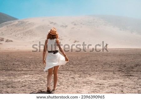 Elegant woman strolling along an arid valley in Cabo de Gata, Spain