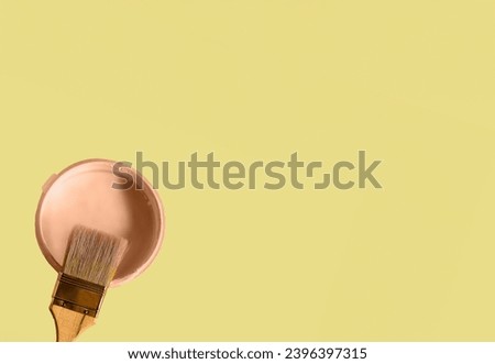 Can with paint of apricot crush color - the fashionable color of 2024, on illuminating yellow color background. Flat lay. Royalty-Free Stock Photo #2396397315