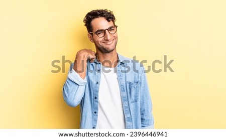 hispanic handsome man laughing cheerfully and confidently with a friendly smile