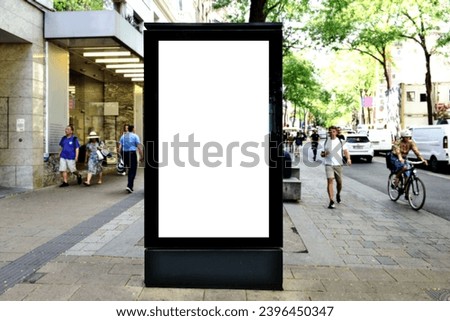 billboard on urban street. blank white poster and advertiser ad space. digital outdoor display lightbox. base for mockup. empty glass display panel. soft streetscape. lush green shopping street