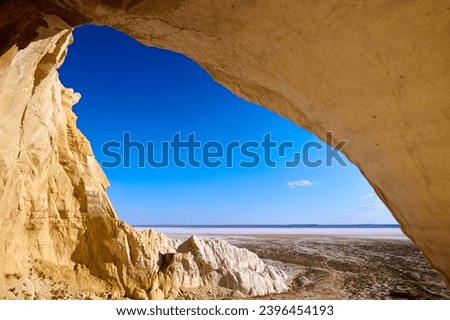Natural arch on the Tuzbair salt marsh. Natural arch at Tuzbair is a natural formation carved by erosion. Salt marsh Tuzbair is one of the most famous attractions of the Mangystau region of Kazakhstan Royalty-Free Stock Photo #2396454193