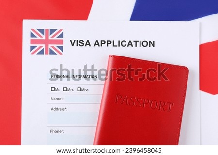 Immigration to United Kingdom. Visa application form and passport on flag, top view