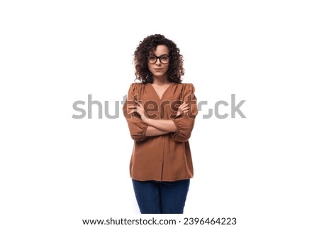 young curly brunette businesswoman dressed in a brown shirt with glasses