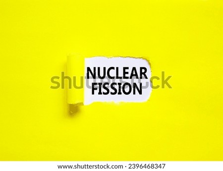 Nuclear fission symbol. Concept words Nuclear fission on beautiful white paper. Beautiful yellow paper background. Business science nuclear fission concept. Copy space. Royalty-Free Stock Photo #2396468347