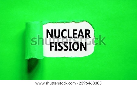 Nuclear fission symbol. Concept words Nuclear fission on beautiful white paper. Beautiful green paper background. Business science nuclear fission concept. Copy space. Royalty-Free Stock Photo #2396468385