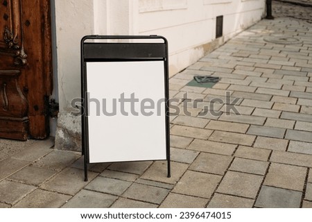 Restaurant sidewalk chalkboard sign board. Blank store signage sign design. White mock up of blank cafe menu stand on a sidewalk