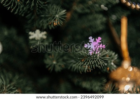 Silver snowflake on a Christmas tree branch. Christmas tree. Celebration atmosphere. 