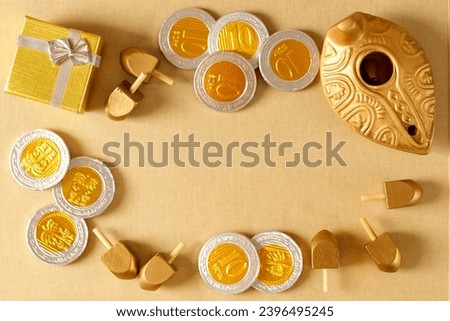 Top view image of jewish holiday Hanukkah with oil jug, wooden dreidels (spinning top) and chocolate coins. Golden bokeh baner