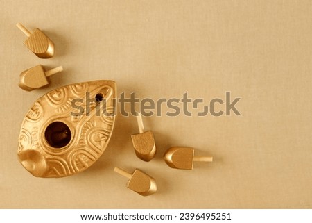 Top view image of jewish holiday Hanukkah with oil jug and wooden dreidels (spinning top). Golden baner
