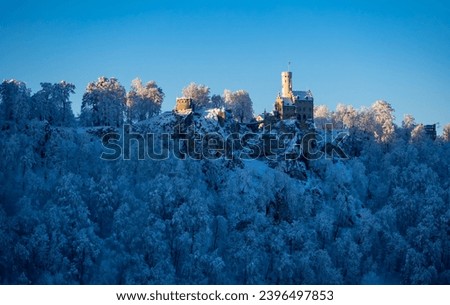 Winter wonderland panorama in Baden-Württemberg, southern Germany. Frosted trees with fairytale castle “Lichtenstein“ near Honau Reutlingen  on a cold sunny december morning. Seasons greetings atmo.