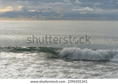Sea waves near shore. Close-up. Foamed seawater in waves of traditional color. Atmosphere of calm serenity. Perfect backdrop for relaxation theme. Elegant nature concept for design. 