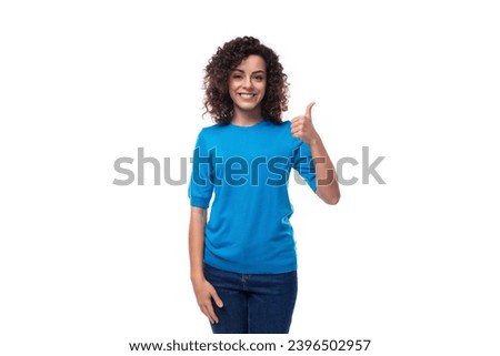 bright curly woman dressed in a blue summer jacket feels confident