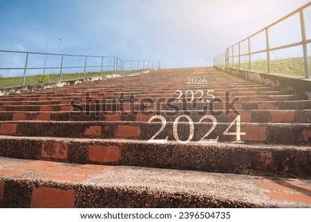 2024 2025 2026 on the upward staircase and the concept of starting in the new year. Royalty-Free Stock Photo #2396504735