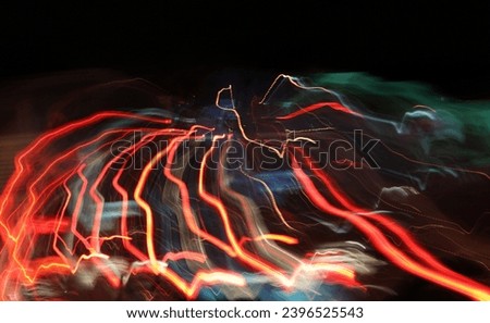 Creative Abstract photo wallpaper of lines lights effect like fireworks on a cityscape city background with colorful color clour glowing neon lines that make this very graphic and artistic art