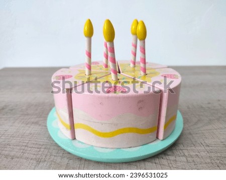 Birthday cake wooden toy with candles. Birthday and celebration concept