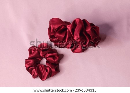 Jakarta, DKI Jakarta, Indonesia - Jan 12 2021: A scrunchie is a fabric-covered elastic hair tie that is used to fasten medium to long hair. ( Red )