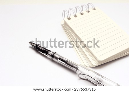 notebook and pen isolated on white background, closeup of photo