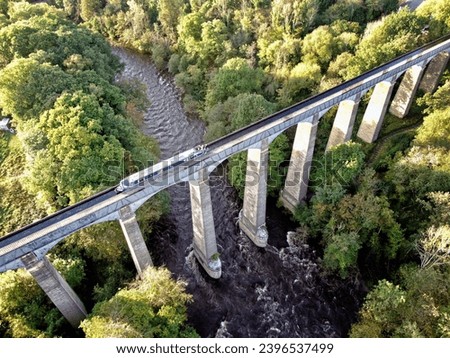 Wide drone shot of Pontcysyllte Aqueduct in Dee Valley, North Wales from above at sunset dusk with canal boat narrow barge crossing waterway Royalty-Free Stock Photo #2396537499