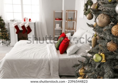 Christmas tree with toys in light bedroom, closeup