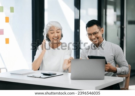Businessman using laptop computer in office. Happy businesspeople, entrepreneur, small business owner working online.