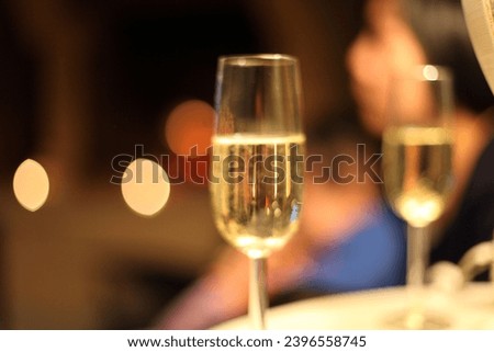 interior photo view of transparent glass of champagne alcohol drink that is served for a christmas party birthday celebrations anniversary fun with guest people