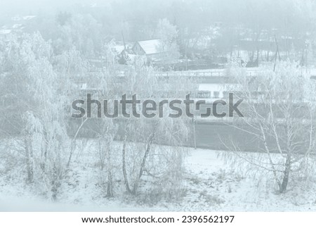 morning fog in winter over houses and trees. winter landscape