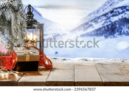 Worn old table of empty space and winter time. Chrismtas decoration of free space for your products. Winter mockup and mountains landscape. 