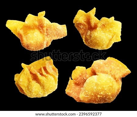 Fried wonton isolated in black background filled with pork meat, clipping path, no shadow. The Japanese food, gyoza, Chinese dim sums