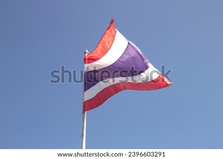 thai flag flying on blue sky background