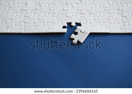 Clean puzzle elements on the background. Empty puzzle piece on table. Teamwork concept.