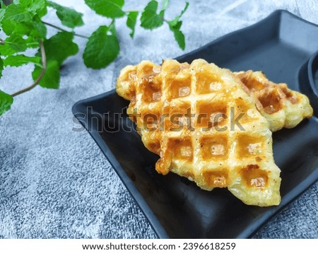 Croissant waffle croffle in black plate with mint leaf