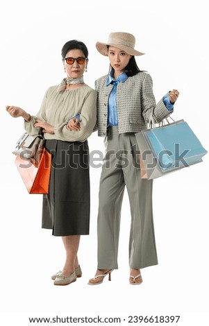 Happy mother and daughter shopping with handbags