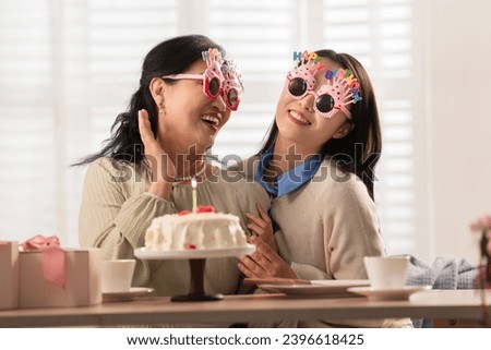 Happy mother and daughter celebrate birthday