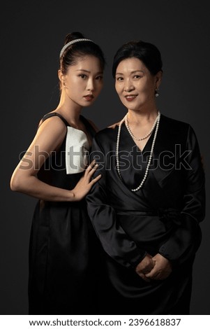 A happy and elegant mother and daughter